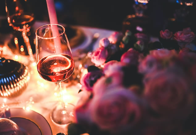 Decorated table with a wine glass and beautiful floral arrangement